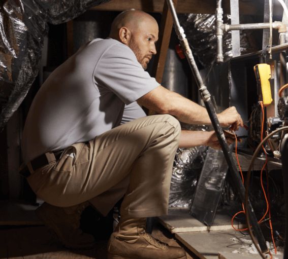 Technician servicing an HVAC system