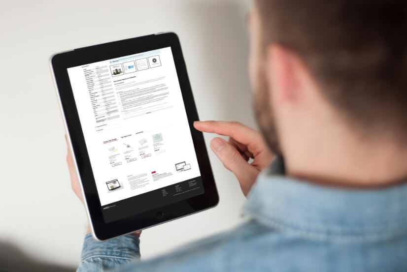 person holding a tablet showing new product page