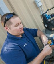 Photo of a technician working on HVAC equipment