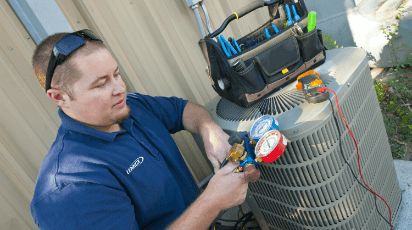 Photo of a technician working on HVAC equipment